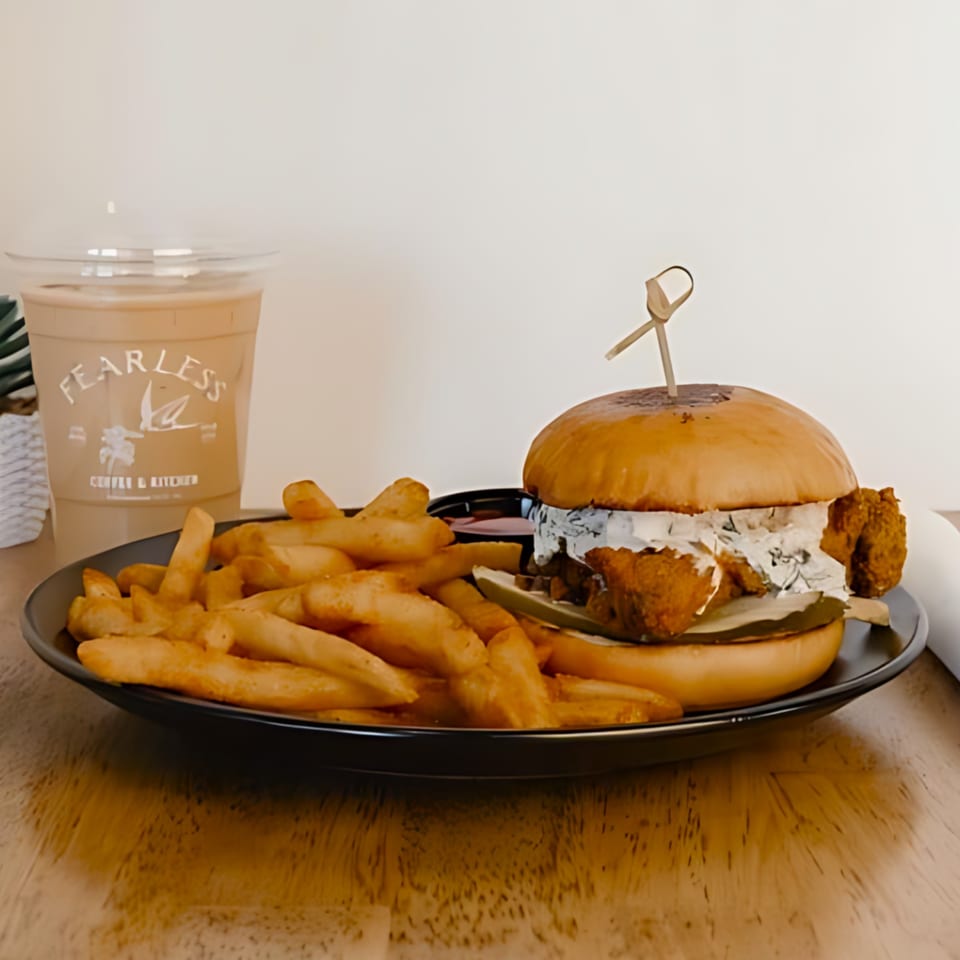 Fearless Coffee & Kitchen fried chicken sandwich with fries and an iced coffee.