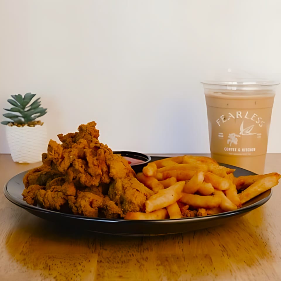 Fearless Coffee & Kitchen's fried chicken strips and fries with a Fearless branded iced coffee.